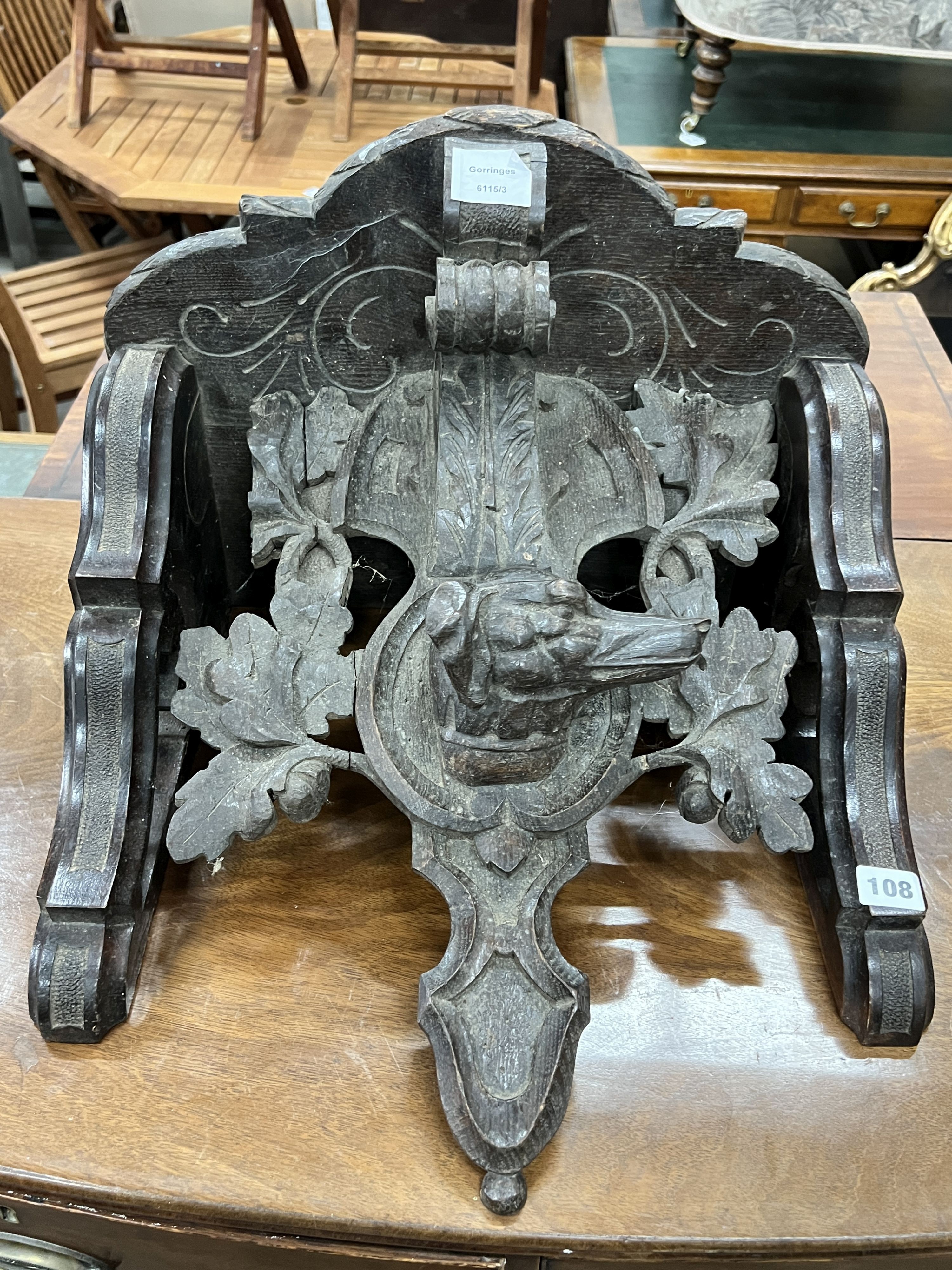 A Victorian carved oak dog's head wall bracket, width 48cm, height 35cm